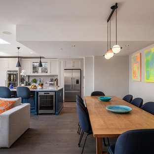 Contemporary dining room in London with grey walls, dark hardwood flooring and brown floors.