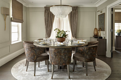 Medium sized contemporary enclosed dining room in London with brown floors, grey walls, dark hardwood flooring and panelled walls.