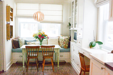 Beach style dining room in Montreal with white walls and medium hardwood flooring.