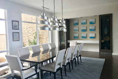 Example of a large trendy dark wood floor and brown floor enclosed dining room design in Austin with white walls