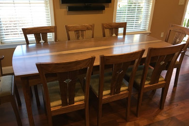 Example of a large trendy medium tone wood floor enclosed dining room design in Boston with beige walls