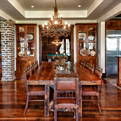 Example of a mountain style dark wood floor and brown floor great room design in Charleston with beige walls