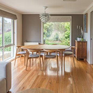 Inspiration for a scandinavian dining room in Canberra - Queanbeyan with grey walls, medium hardwood floors, no fireplace and brown floor.