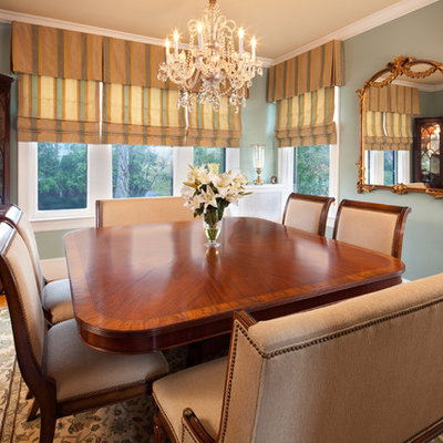 Example of a large classic medium tone wood floor and brown floor enclosed dining room design in DC Metro with green walls and no fireplace