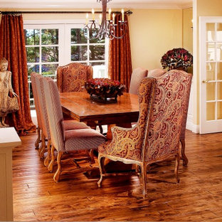 Inspiration for a timeless dark wood floor dining room remodel in Seattle with yellow walls