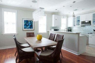 Medium sized coastal kitchen/dining room in Miami with grey walls and medium hardwood flooring.