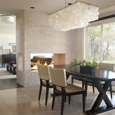 Trendy travertine floor and beige floor dining room photo in Denver with a two-sided fireplace and a tile fireplace