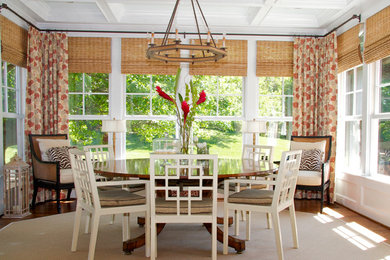 Example of a classic medium tone wood floor dining room design in DC Metro with white walls