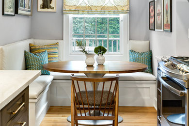 This is an example of a medium sized classic kitchen/dining room in New York with grey walls, medium hardwood flooring and brown floors.