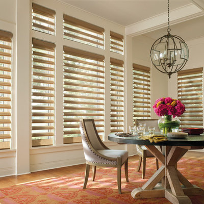 Inspiration for a mid-sized transitional light wood floor and brown floor enclosed dining room remodel in New York with beige walls and no fireplace