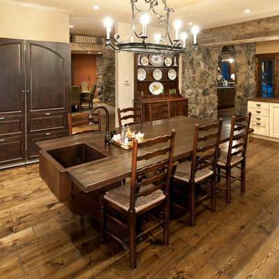 Example of a mountain style medium tone wood floor kitchen/dining room combo design in Denver with white walls