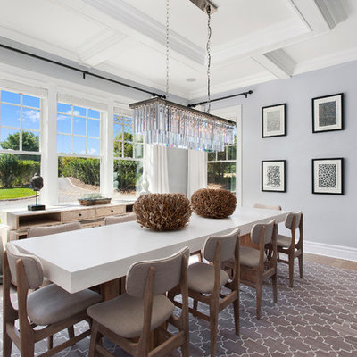 Enclosed dining room - mid-sized transitional medium tone wood floor and beige floor enclosed dining room idea in New York with gray walls