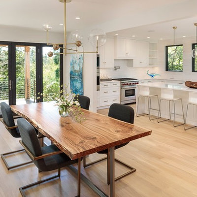 Danish light wood floor kitchen/dining room combo photo in Portland with white walls