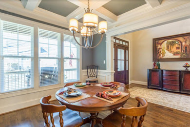 Mid-sized elegant medium tone wood floor and brown floor enclosed dining room photo in Other with green walls and no fireplace