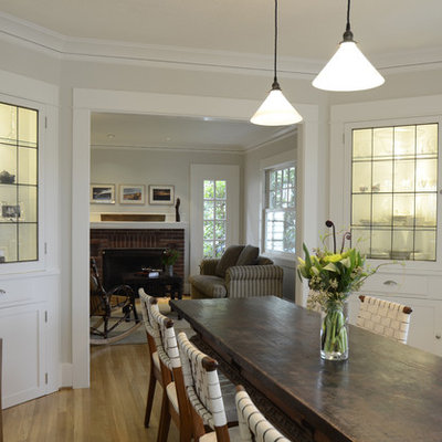 Example of a mountain style medium tone wood floor enclosed dining room design in Portland with gray walls