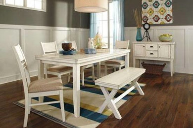 Mid-sized trendy medium tone wood floor enclosed dining room photo in Boston with gray walls