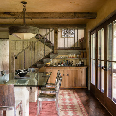 Example of a mountain style dark wood floor dining room design in Other with beige walls