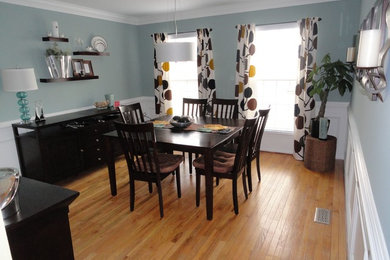 This is an example of a small retro enclosed dining room in DC Metro with grey walls, medium hardwood flooring and no fireplace.