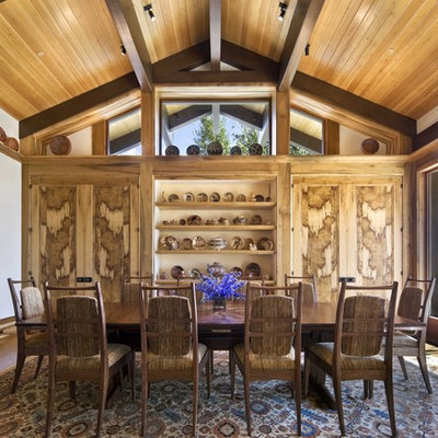 Mid-sized mountain style dark wood floor enclosed dining room photo in New York with white walls