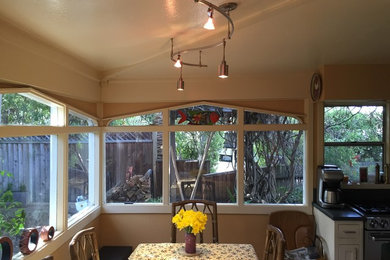 Photo of a small traditional kitchen/dining room in San Francisco with beige walls and light hardwood flooring.