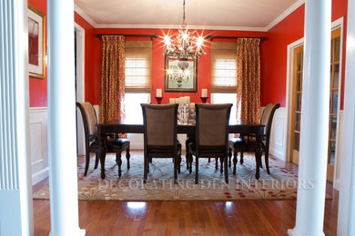 Elegant medium tone wood floor dining room photo in Philadelphia with red walls