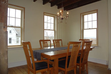Mid-sized elegant medium tone wood floor enclosed dining room photo in Philadelphia with beige walls and no fireplace