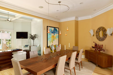 Mid-sized minimalist light wood floor and brown floor enclosed dining room photo in Charleston with yellow walls and no fireplace