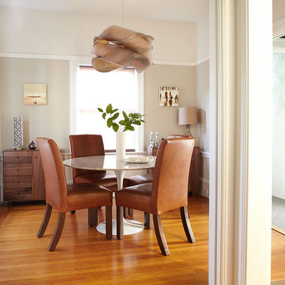Inspiration for a contemporary medium tone wood floor enclosed dining room remodel in San Francisco with beige walls