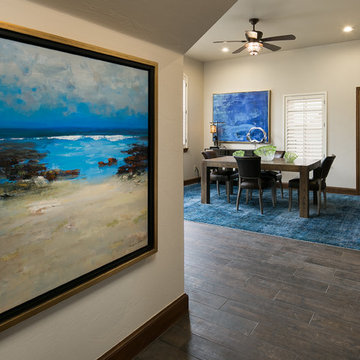 Dining Room with Blue Rug and Paintings