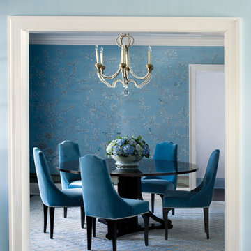Dining room with decorative wallpaper and chandelier