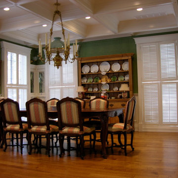 Dining room with green fabric wall upholstery