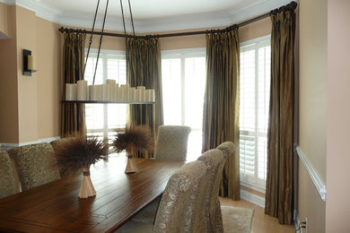 Mid-sized transitional light wood floor enclosed dining room photo in Jacksonville with beige walls and no fireplace
