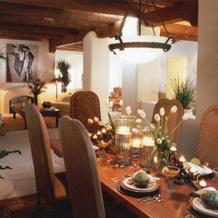 Foto de comedor de estilo americano, grande, abierto, con paredes amarillas, chimenea de doble cara y marco de chimenea de yeso