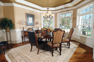 This is an example of a medium sized classic dining room in Houston with beige walls and medium hardwood flooring.