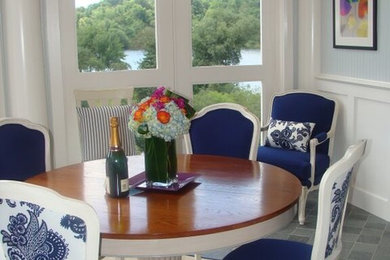 This is an example of a medium sized traditional enclosed dining room in New York with blue walls and carpet.