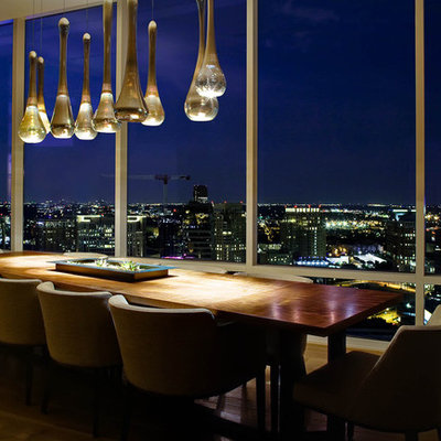 Example of a trendy medium tone wood floor dining room design in Dallas