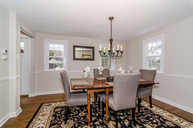 This is an example of a medium sized classic enclosed dining room in Philadelphia with beige walls, carpet and no fireplace.