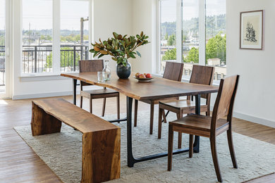 Example of a minimalist dining room design in Portland with white walls