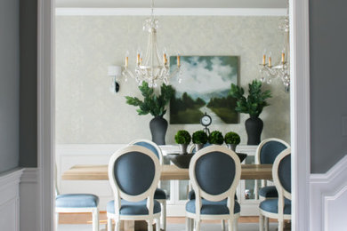 Example of a large classic light wood floor dining room design in New York with white walls