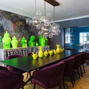 Large bohemian enclosed dining room in London with grey walls, brown floors, medium hardwood flooring, no fireplace and wallpapered walls.