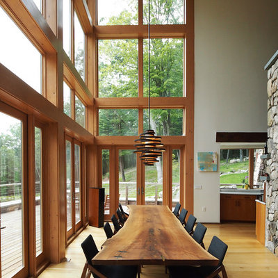 Great room - large rustic medium tone wood floor and brown floor great room idea in New York with white walls