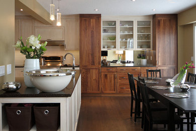 Kitchen/dining room combo - mid-sized transitional medium tone wood floor and brown floor kitchen/dining room combo idea in Calgary with beige walls