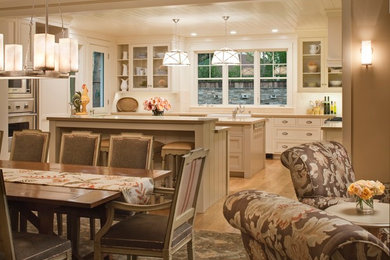 This is an example of a large farmhouse kitchen/dining room in San Francisco with light hardwood flooring, beige walls, no fireplace and brown floors.
