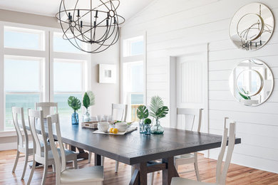 Inspiration for a large coastal medium tone wood floor and brown floor great room remodel in Other with white walls