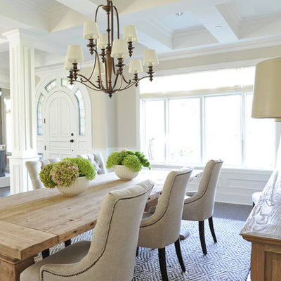 Example of a classic brown floor dining room design in Vancouver with beige walls