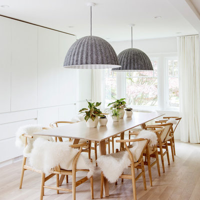 Example of a large danish light wood floor and beige floor dining room design in Vancouver with white walls and no fireplace