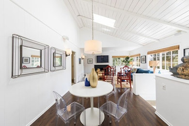 Small beach style dark wood floor and brown floor great room photo in Los Angeles with white walls and no fireplace