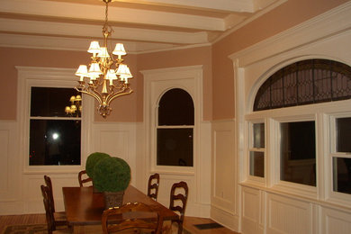 Example of a mid-sized classic light wood floor enclosed dining room design in New York with beige walls
