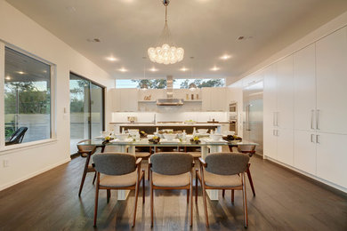Large kitchen/dining room in Austin with white walls, dark hardwood flooring and brown floors.