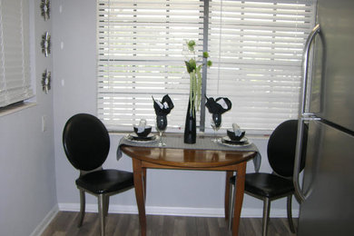 Example of a mid-sized transitional dark wood floor and brown floor kitchen/dining room combo design in Tampa with gray walls and no fireplace